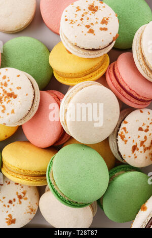 Heap of colorful macarons with various fillings. Overhead shot. Stock Photo