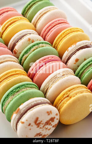 Colorful french macarons on a baking tray. Traditional french dessert. Stock Photo