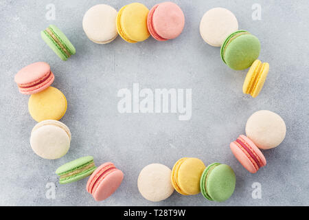 Frame made of colorful french macarons. Creative background with space for text. Flat lay. Stock Photo