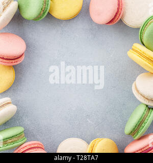 Frame made of colorful french macarons. Creative background with space for text. Flat lay. Stock Photo