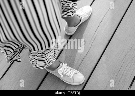 woman dress and feet in sneakers in motion Stock Photo