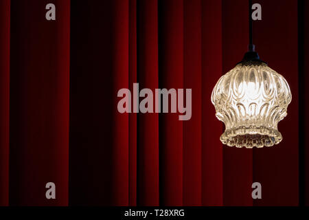 Classic theater, cinema, foyer interior background with red velved curtain and old vintage lamp copy space Stock Photo