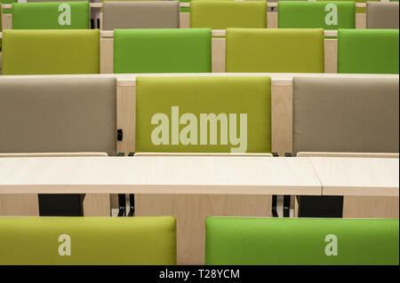 Colourful green seat covers in a university lecture theatre. Stock Photo