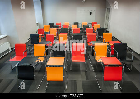 Colourful seats in a university lecture theatre. Stock Photo