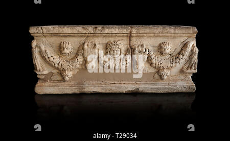 Roman relief garland sculpted sarcophagus.  Adana Archaeology Museum, Turkey. Against a black background Stock Photo