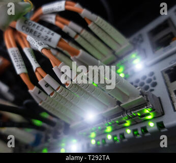 Close up fiber optic cable. Servers racks. Severs computer in a rack at the large data center. Stock Photo
