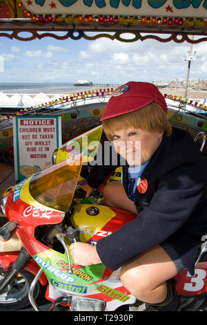 Wee Jimmy Krankie pictured on a fairground ride on the Central Pier in Blackpool. The veteran comedienne and entertainer was promoting her forthcoming show entitled the Best of British Variety Tour 2008, which also featured Frank Carson, Cannon & Ball, Paul Daniels, Brotherhood of Man and Jimmy Cricket. The Krankies comprised husband and wife Janette and Ian Tough and portrayed schoolboy Wee Jimmy Krankie (Janette), and Jimmy's father (Ian), though in their comedy act they also portray other characters. Stock Photo