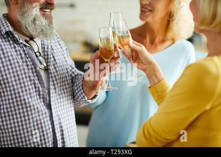 Clinking flutes together Stock Photo