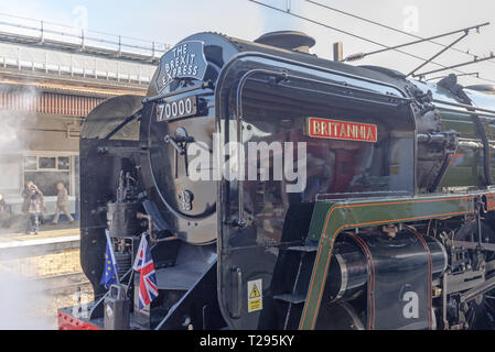 York, UK. 30th March 2019. A steam locomotive “The Brexit Express” at the platform on York Station. Steam is emitted from the engine and flags adorn the front. Credit: Jack Cousin/Alamy Live News Stock Photo