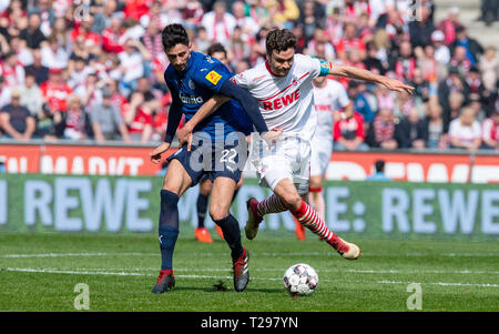 Cologne, Germany. 31st Mar, 2019.  Soccer: 2nd Bundesliga, 1st FC Cologne - Holstein Kiel, 27th matchday in the Rhein-Energie-Stadion. Kiel's Atakan Karazor (l) and Cologne's Jonas Hector fight for the ball. Photo: Guido Kirchner/dpa - IMPORTANT NOTE: In accordance with the requirements of the DFL Deutsche Fußball Liga or the DFB Deutscher Fußball-Bund, it is prohibited to use or have used photographs taken in the stadium and/or the match in the form of sequence images and/or video-like photo sequences. Credit: dpa picture alliance/Alamy Live News Stock Photo