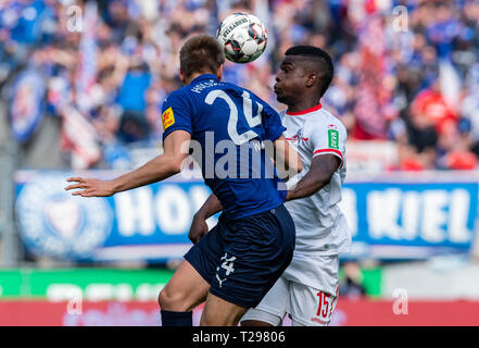 Cologne, Germany. 31st Mar, 2019.  Soccer: 2nd Bundesliga, 1st FC Cologne - Holstein Kiel, 27th matchday in the Rhein-Energie-Stadion. Cologne's Jhon Cordoba (r) and Kiel's Hauke Wahl fight for the ball. Photo: Guido Kirchner/dpa - IMPORTANT NOTE: In accordance with the requirements of the DFL Deutsche Fußball Liga or the DFB Deutscher Fußball-Bund, it is prohibited to use or have used photographs taken in the stadium and/or the match in the form of sequence images and/or video-like photo sequences. Credit: dpa picture alliance/Alamy Live News Stock Photo
