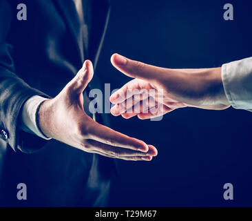 concept of partnership in business:two businessmen stretches his Stock Photo