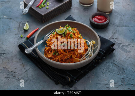 Mee goreng mamak, Indonesian and Malaysian cuisine, spicy fried noodles in a plate, copy space. Stock Photo