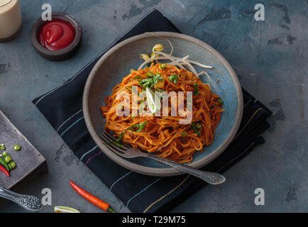 Spicy mee goreng mamak, malaysian or singaporean fried noodles with ketchup and chili. Stock Photo