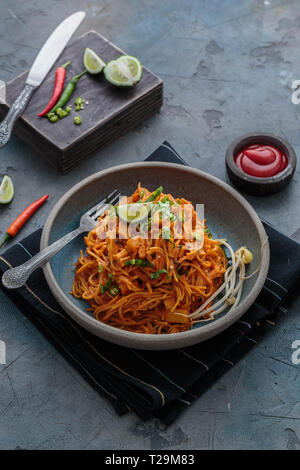 Spicy mee goreng mamak, malaysian or singaporean fried noodles with ketchup and chili. Stock Photo