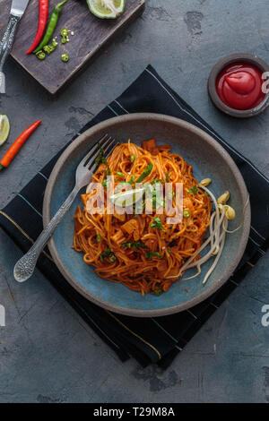 Indian mee goreng or mee goreng mamak, Indonesian and Malaysian cuisine, spicy fried noodles in a plate, top view. Stock Photo