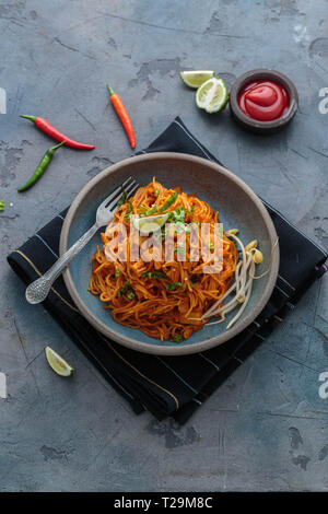 Indian mee goreng, spicy fried noodles in a plate, Singaporean and Malaysian cuisine copy space. Stock Photo