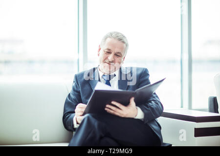 experienced lawyer reviews the documents with the terms of a new contract Stock Photo