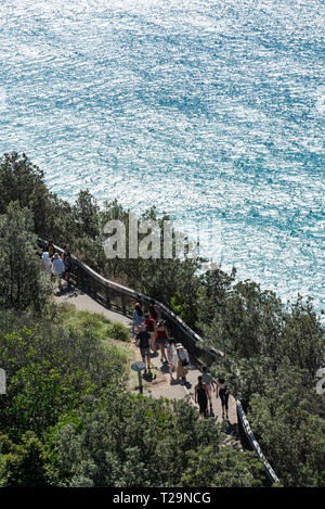 Travellers walking to and from the most easterly point of the Australian mainland, Cape Byron, NSW, Australia. Stock Photo