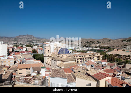 picture taken from the castle of the municipality of petrer in the province of alicante, spain with houses, church of san bartolome and mountains in t Stock Photo