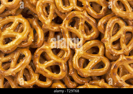 Lot of whole mini salted pretzels stack flatlay as abstract background. Copy space for your text. Stock Photo