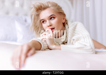 Slim nude blonde haired young woman naked in woodland with bluebells