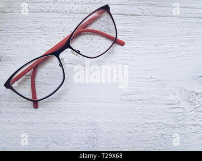 Eye glasses on white wooden background Space for copy Stock Photo