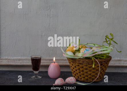 Easter decoration with painted eggs. White vintage wall background. Copy space. Stock Photo