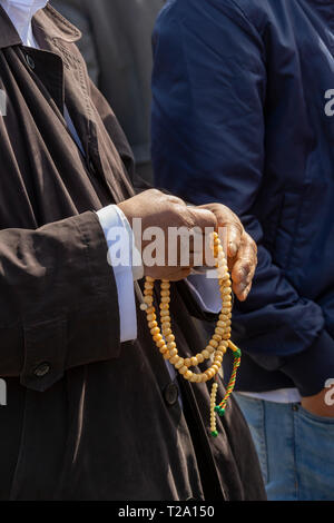 Detroit, Michigan - A Muslim man holds a misbaá¸¥ah, Islamic prayer beads. The misbahah is used when performing dhikr--the repetition of short phrases Stock Photo