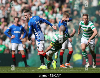 Rangers' Ryan Kent (left) and Celtic's Scott Brown clash during the Ladbrokes Scottish Premiership match at Celtic Park, Glasgow. Stock Photo