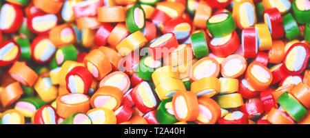Colorful lollipops and different colored round candy. Top view. Stock Photo