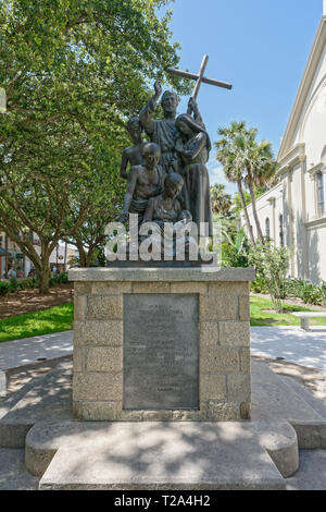 St Augustine, Florida - June 15, 2018: This bronze statue is in memory of Father Pedro Camps the spiritual leader of immigrants from the Island of Min Stock Photo