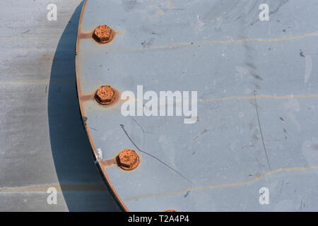 Rusting bolts on the cap of an industrial pressure vessel. Metal bolts. Stock Photo