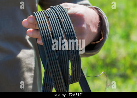 Used generator belt from car in hand Stock Photo