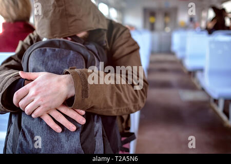 Man in jacket sleeping in commuter train returrning home after work. Stock Photo