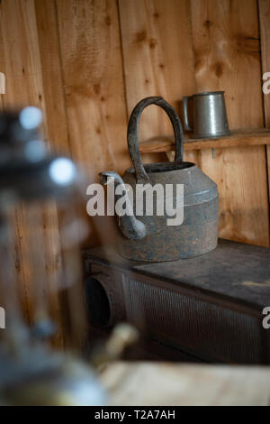 kettle on a stove in a trapper's hut / cabin Stock Photo