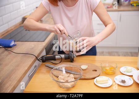 Ground meat in a bowl of blender Minced meat . cooking process Stock Photo