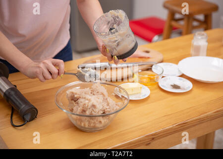 Ground meat in a bowl of blender Minced meat . cooking process Stock Photo