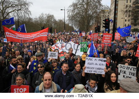 Protesters hold red union flags up in the air at a People's Vote march in London Stock Photo