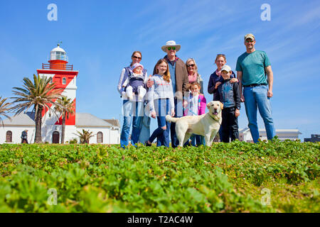 A family and their dog by the lighthouse on the promenade, Sea Point, Cape Town. Stock Photo