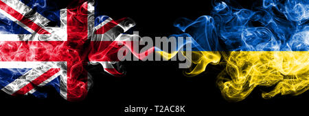 United Kingdom vs Ukraine, Ukrainian smoky mystic flags placed side by side. Thick colored silky smoke flags of Great Britain and Ukraine, Ukrainian. Stock Photo
