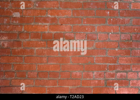 Reddish orange brick wall background showing some details in bricks. Stock Photo