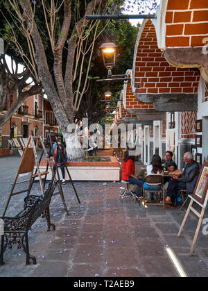 Old street with artists, workshops and paintings in Mexican Artist Quarter,  Barrio Del Artista, Calle 8 Norte, Puebla, Mexico Stock Photo
