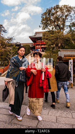 Two women walking towards camera, Tsurugaoka Hachimangu Shrine, Kamakura, Japan Stock Photo