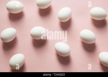 White eggs on pink background Stock Photo
