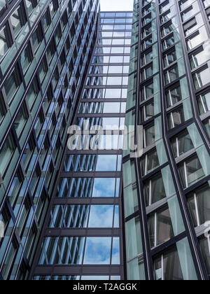 Hamburg, Germany - May 11, 2018: View from below at facade of modern office building in Hamburg, called dancing towers. Stock Photo