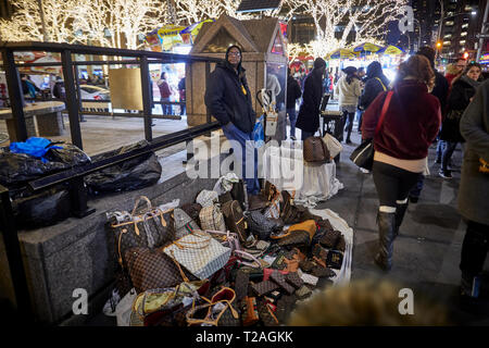 vendor illegally selling imitation name brand handbags on Canal Street  Manhattan New York Stock Photo - Alamy