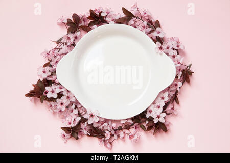 Spring table setting with a white plate and sherry blossom Stock Photo