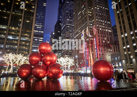 Large oversized giant baubles Christmas Decorations, 6th Avenue, Manhattan, New York at night Stock Photo