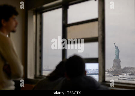 Landmark Statue of Liberty neoclassical sculpture on Liberty Island in the harbor harbour taken from a passing Staten Island Ferry USA  Manhattan, New Stock Photo